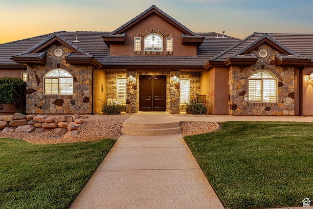 880 N 370 W, La Verkin, UT 84745 - view of front of property featuring stone siding, a tiled roof, a yard, and stucco siding