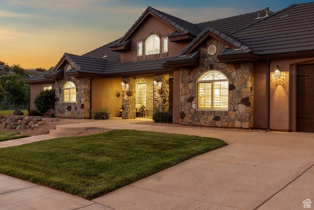 880 N 370 W, La Verkin, UT 84745 - view of front of property featuring stone siding, a yard, a tile roof, and concrete driveway