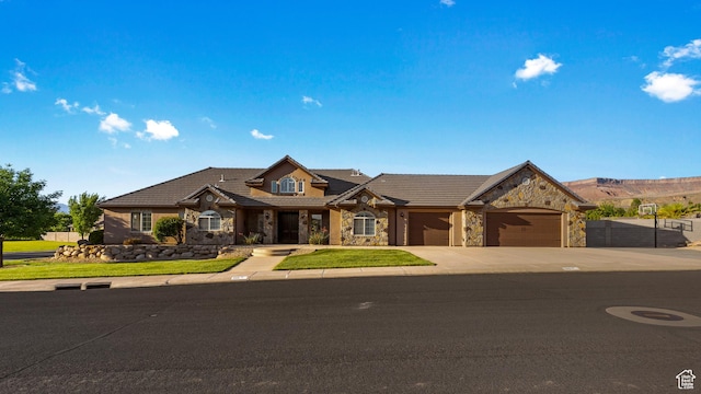 880 N 370 W, La Verkin, UT 84745 - traditional home with stone siding, a garage, concrete driveway, and a tile roof