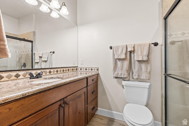880 N 370 W, La Verkin, UT 84745 - full bathroom with vanity, a tile shower, wood finished floors, baseboards, and toilet