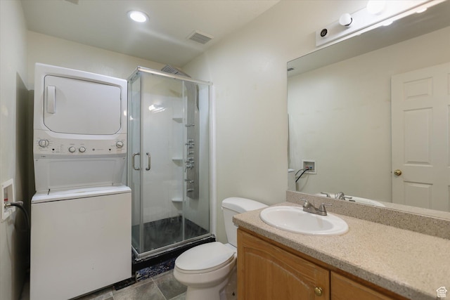 894 N Main St Unit 13, Orem, UT 84057 - bathroom with stacked washer / drying machine, a shower stall, toilet, and vanity