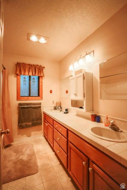 349 W 100 N, Pine Valley, UT 84781 - bathroom with double vanity and a textured ceiling