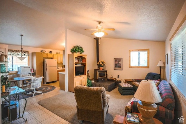 349 W 100 N, Pine Valley, UT 84781 - living area featuring lofted ceiling, a wood stove, healthy amount of natural light, a ceiling fan, and a textured ceiling