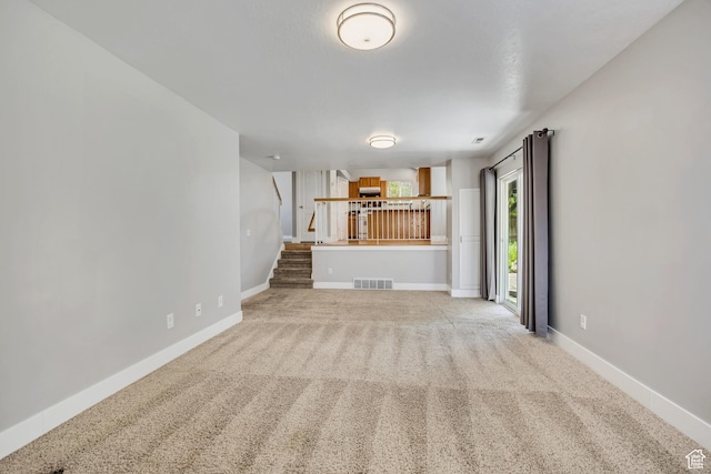 13928 S Ben Lomond Peak Dr W, Riverton, UT 84096 - unfurnished living room featuring carpet floors, baseboards, and stairs