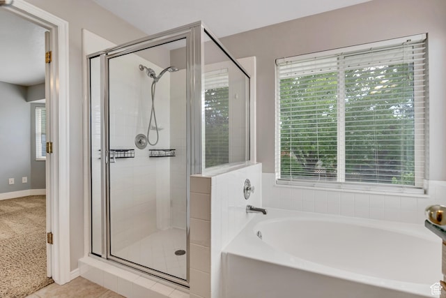 13928 S Ben Lomond Peak Dr W, Riverton, UT 84096 - bathroom featuring a garden tub, a shower stall, and baseboards