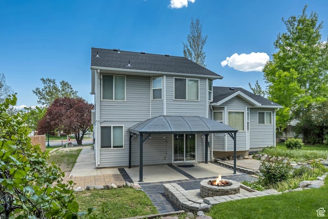 13928 S Ben Lomond Peak Dr W, Riverton, UT 84096 - back of property featuring a fire pit and a patio area