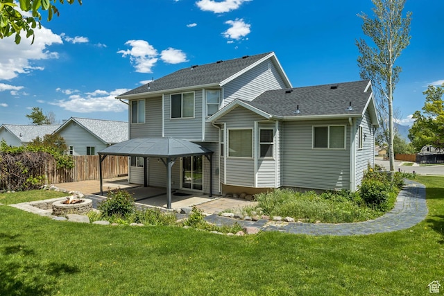 13928 S Ben Lomond Peak Dr W, Riverton, UT 84096 - back of property featuring a patio area, an outdoor fire pit, and a shingled roof