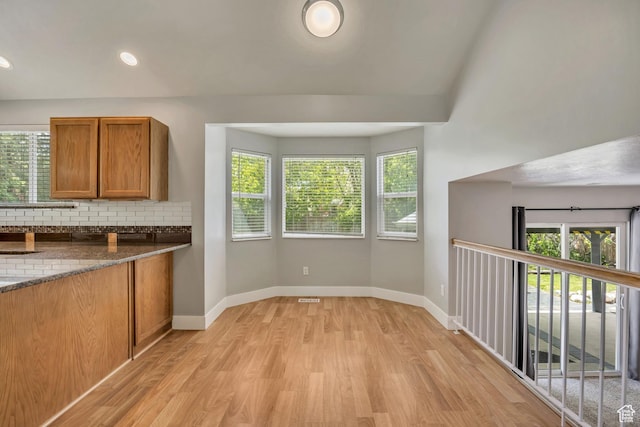 13928 S Ben Lomond Peak Dr W, Riverton, UT 84096 - kitchen with light wood finished floors, brown cabinetry, healthy amount of natural light, decorative backsplash, and recessed lighting