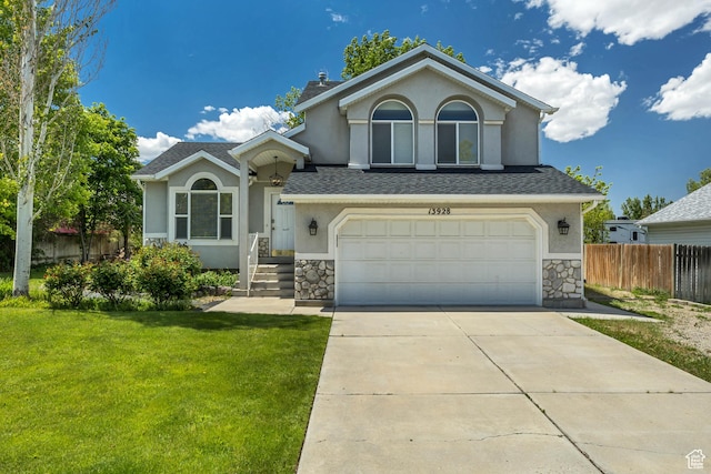13928 S Ben Lomond Peak Dr W, Riverton, UT 84096 - view of front of property with an attached garage, stucco siding, driveway, stone siding, and a chimney