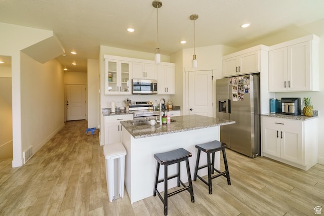 988 E 1300 S, Provo, UT 84606 - kitchen featuring stainless steel appliances, light wood-type flooring, a kitchen breakfast bar, white cabinetry, and recessed lighting
