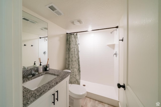 988 E 1300 S, Provo, UT 84606 - full bath featuring toilet, vanity, tiled shower, wood finished floors, and a textured ceiling