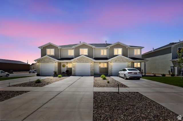 917 N 100 W, Nephi, UT 84648 - view of front of house with driveway, stone siding, an attached garage, and board and batten siding