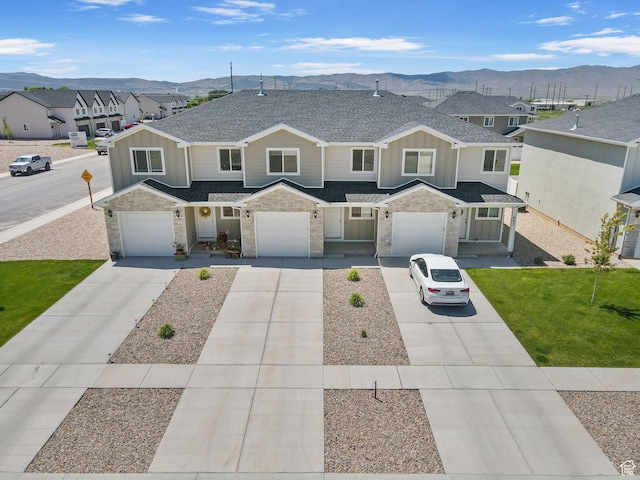 917 N 100 W, Nephi, UT 84648 - townhome / multi-family property featuring board and batten siding, concrete driveway, a mountain view, stone siding, and a shingled roof