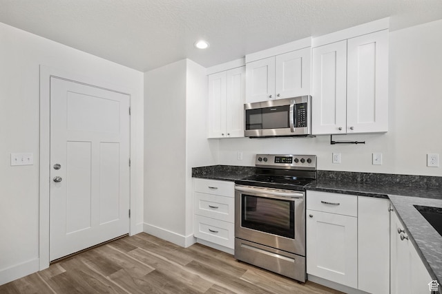 917 N 100 W, Nephi, UT 84648 - kitchen featuring stainless steel appliances, white cabinetry, light wood-style flooring, recessed lighting, and baseboards