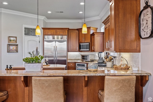 2204 N Bridge Water Rd, Cedar City, UT 84721 - kitchen with stainless steel appliances, brown cabinetry, hanging light fixtures, tasteful backsplash, and crown molding
