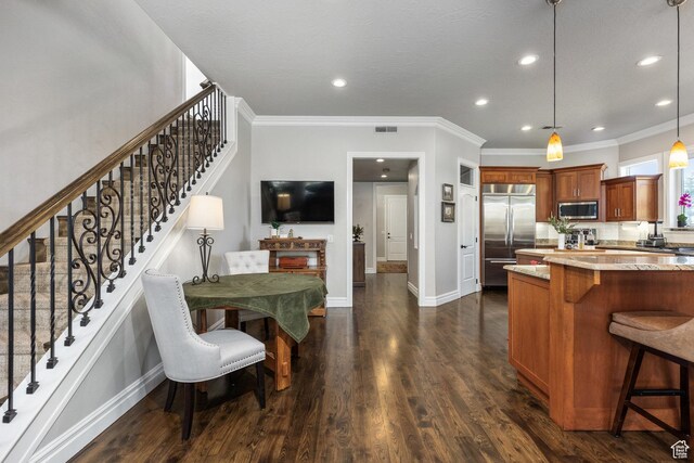 2204 N Bridge Water Rd, Cedar City, UT 84721 - kitchen featuring stainless steel appliances, a breakfast bar, brown cabinets, light stone counters, and dark wood-style floors