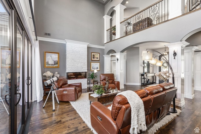 2204 N Bridge Water Rd, Cedar City, UT 84721 - living area with ornate columns, arched walkways, a towering ceiling, dark wood finished floors, and a fireplace