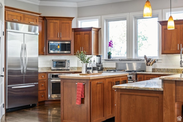 2204 N Bridge Water Rd, Cedar City, UT 84721 - kitchen with built in appliances, plenty of natural light, ornamental molding, and brown cabinets