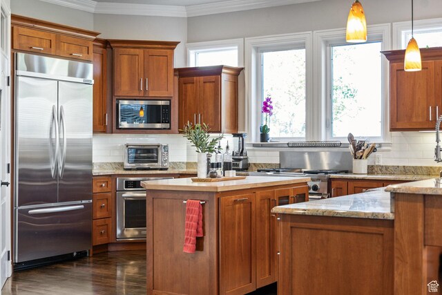2204 N Bridge Water Rd, Cedar City, UT 84721 - kitchen with appliances with stainless steel finishes, healthy amount of natural light, ornamental molding, and brown cabinetry