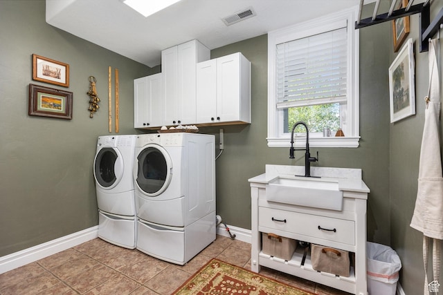 2204 N Bridge Water Rd, Cedar City, UT 84721 - washroom featuring independent washer and dryer, cabinet space, baseboards, and light tile patterned floors