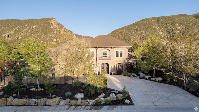 2204 N Bridge Water Rd, Cedar City, UT 84721 - view of front facade with a mountain view, stucco siding, and driveway