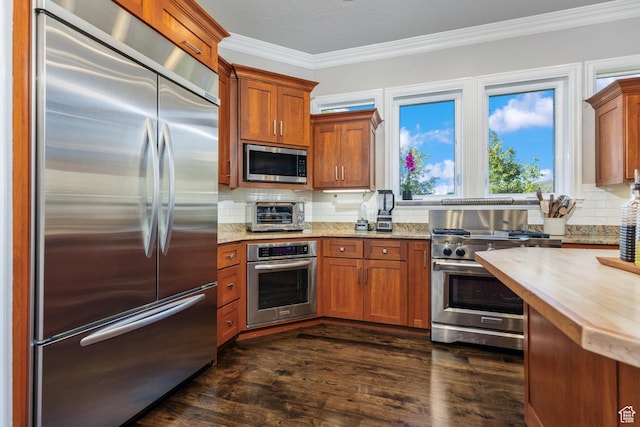 2204 N Bridge Water Rd, Cedar City, UT 84721 - kitchen featuring appliances with stainless steel finishes, crown molding, tasteful backsplash, and brown cabinets