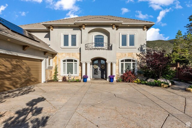 2204 N Bridge Water Rd, Cedar City, UT 84721 - mediterranean / spanish-style house featuring french doors, a balcony, stucco siding, concrete driveway, and a tile roof