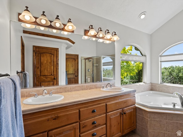 5577 E Elkhorn Dr, Eden, UT 84310 - full bath featuring a stall shower, double vanity, a bath, and vaulted ceiling