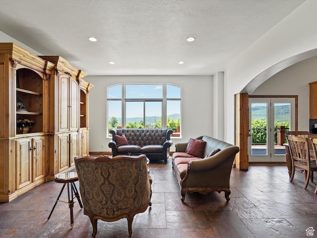5577 E Elkhorn Dr, Eden, UT 84310 - living area with stone tile floors, arched walkways, and recessed lighting