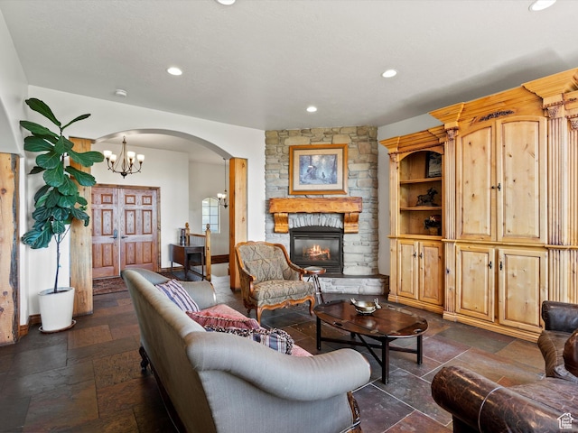 5577 E Elkhorn Dr, Eden, UT 84310 - living area with stone tile floors, arched walkways, recessed lighting, a stone fireplace, and baseboards
