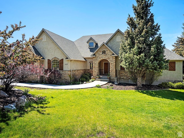 5577 E Elkhorn Dr, Eden, UT 84310 - french country inspired facade featuring stone siding, stucco siding, and a front yard