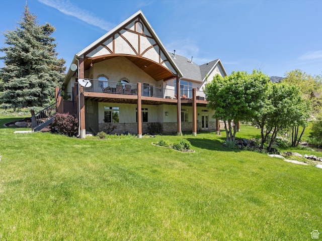 5577 E Elkhorn Dr, Eden, UT 84310 - back of property with a yard, stucco siding, stone siding, a deck, and stairway