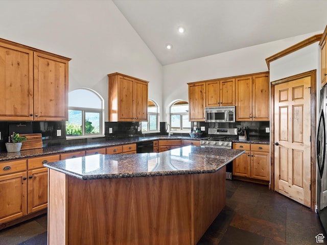 5577 E Elkhorn Dr, Eden, UT 84310 - kitchen featuring appliances with stainless steel finishes, high vaulted ceiling, a sink, brown cabinets, and recessed lighting