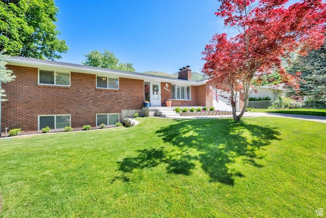 1607 Mountain Cir, Fruit Heights, UT 84037 - single story home featuring a garage, a chimney, brick siding, a front lawn, and concrete driveway