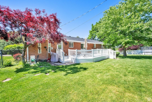 1607 Mountain Cir, Fruit Heights, UT 84037 - rear view of house featuring a trampoline, a wooden deck, and brick siding
