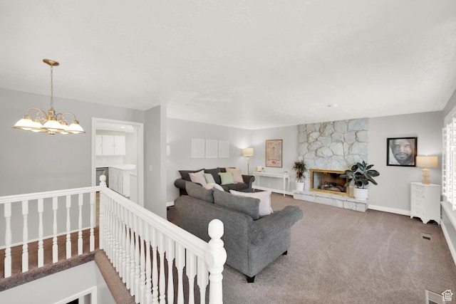 1607 Mountain Cir, Fruit Heights, UT 84037 - living area featuring carpet, baseboards, a stone fireplace, and a chandelier