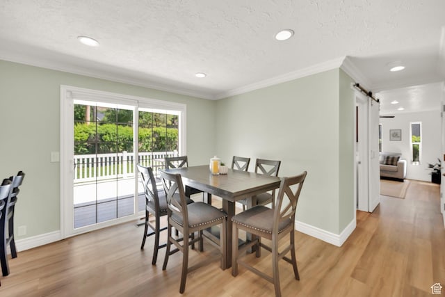 1607 Mountain Cir, Fruit Heights, UT 84037 - dining area featuring a barn door, crown molding, light wood-type flooring, a textured ceiling, and baseboards
