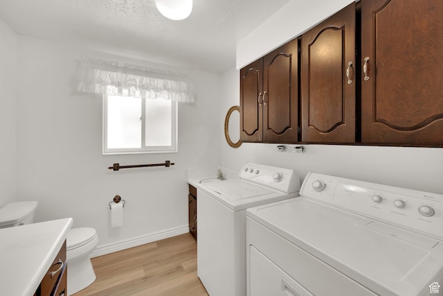 1607 Mountain Cir, Fruit Heights, UT 84037 - laundry area with washer and clothes dryer, light wood finished floors, baseboards, and a textured ceiling