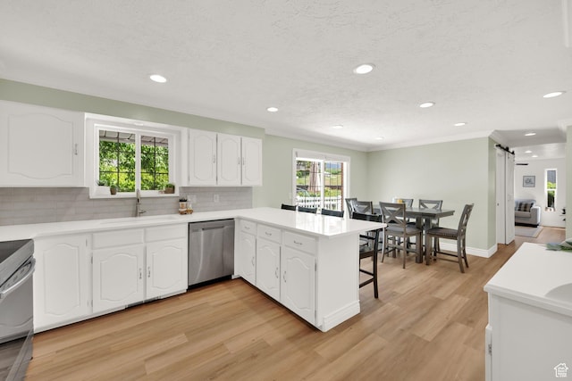 1607 Mountain Cir, Fruit Heights, UT 84037 - kitchen with dishwasher, a sink, a peninsula, decorative backsplash, and white cabinetry