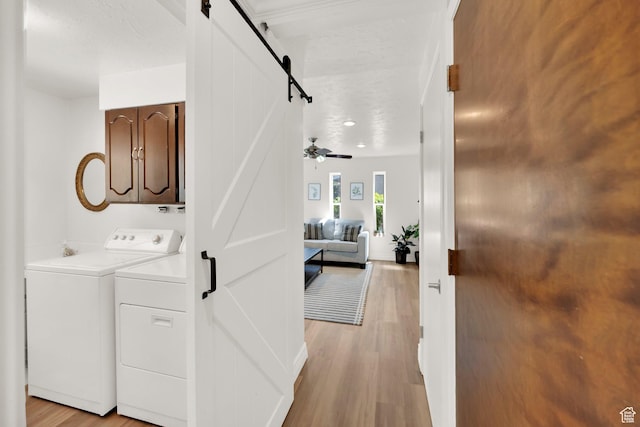 1607 Mountain Cir, Fruit Heights, UT 84037 - laundry room with a barn door, washer and dryer, and light wood-type flooring