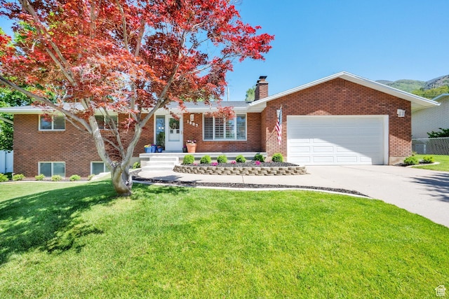 1607 Mountain Cir, Fruit Heights, UT 84037 - view of front of home featuring brick siding, concrete driveway, and a chimney