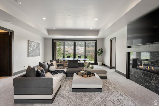 942 N Explorer Peak Dr Unit 420, Heber City, UT 84032 - carpeted living room with a tray ceiling, baseboards, a high end fireplace, and recessed lighting