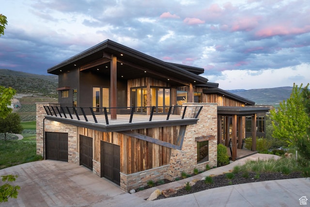 942 N Explorer Peak Dr Unit 420, Heber City, UT 84032 - view of front facade with a balcony, driveway, a mountain view, and an attached garage