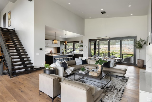 942 N Explorer Peak Dr Unit 420, Heber City, UT 84032 - living area featuring a high ceiling, light wood finished floors, recessed lighting, and stairs