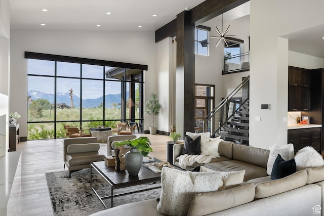 942 N Explorer Peak Dr Unit 420, Heber City, UT 84032 - living area with a high ceiling, light wood finished floors, a mountain view, stairs, and recessed lighting