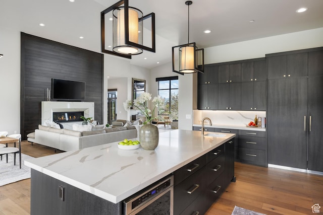 942 N Explorer Peak Dr Unit 420, Heber City, UT 84032 - kitchen featuring a sink, wood finished floors, dark cabinets, and recessed lighting