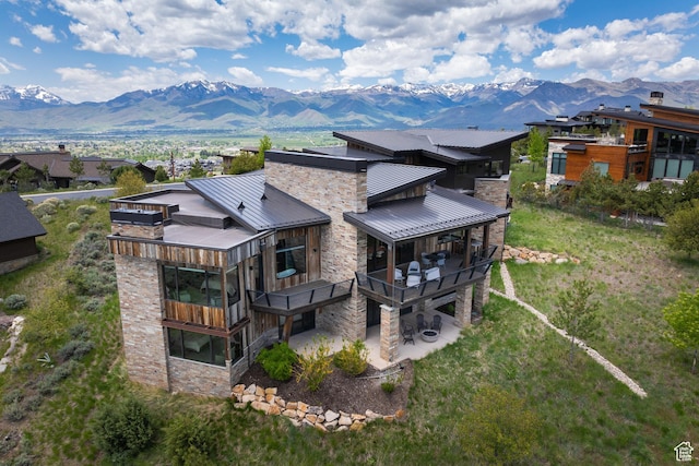 942 N Explorer Peak Dr Unit 420, Heber City, UT 84032 - back of property featuring stone siding, a mountain view, metal roof, a standing seam roof, and a patio