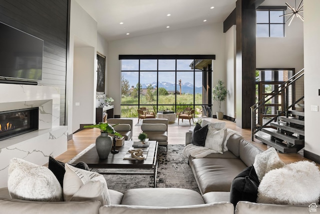 942 N Explorer Peak Dr Unit 420, Heber City, UT 84032 - living area featuring high vaulted ceiling, stairway, wood finished floors, a premium fireplace, and recessed lighting