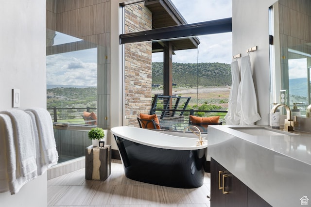 942 N Explorer Peak Dr Unit 420, Heber City, UT 84032 - bathroom featuring vanity, a freestanding tub, plenty of natural light, and tile patterned flooring