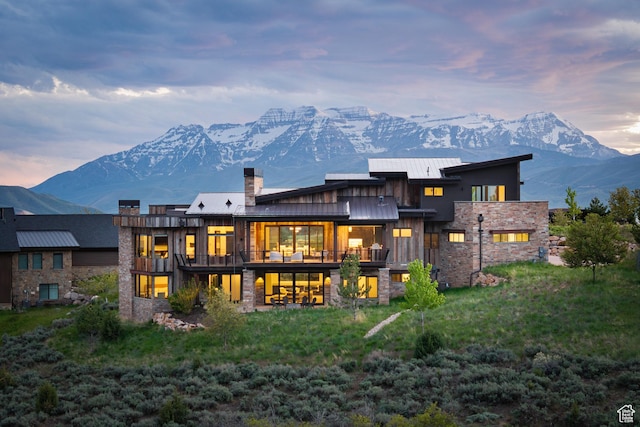 942 N Explorer Peak Dr Unit 420, Heber City, UT 84032 - rear view of property featuring stone siding, a standing seam roof, a mountain view, a chimney, and metal roof
